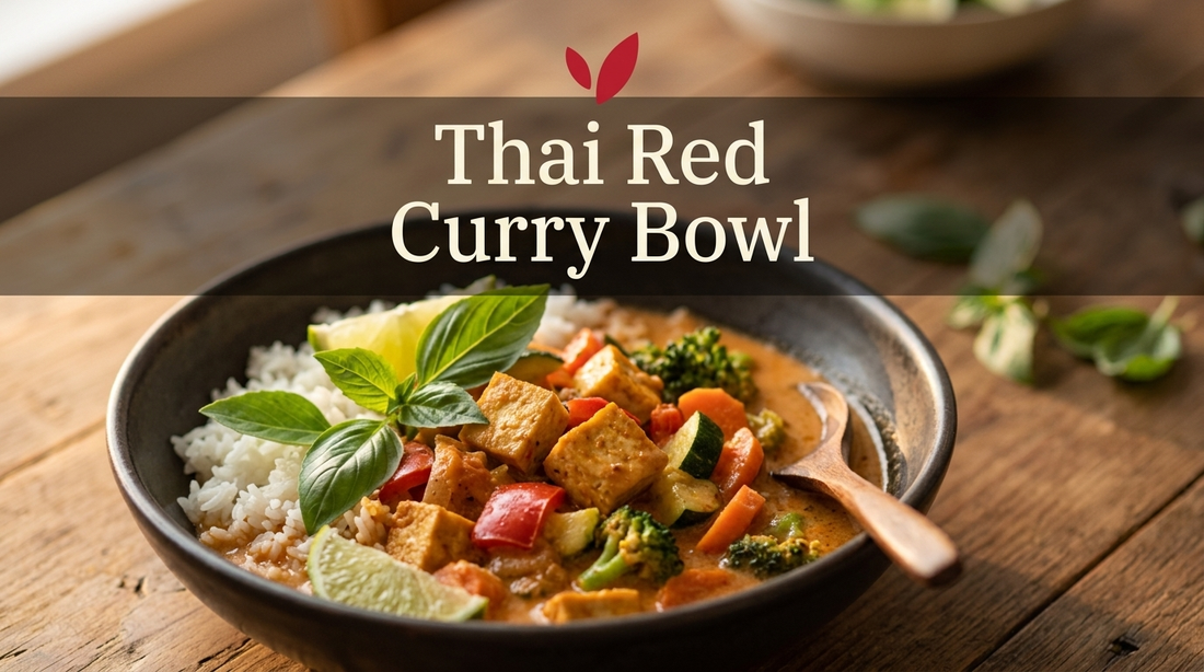 Thai red curry bowl with tofu and vegetables in coconut sauce over jasmine rice, topped with fresh basil and lime, Hanuvier Wellness Hub