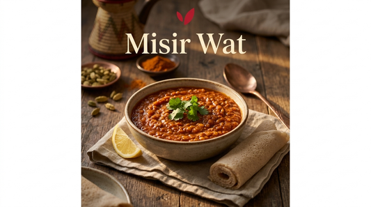 Misir Wat recipe cover - a bowl of Ethiopian berbere-spiced red lentil stew with injera and a lemon wedge