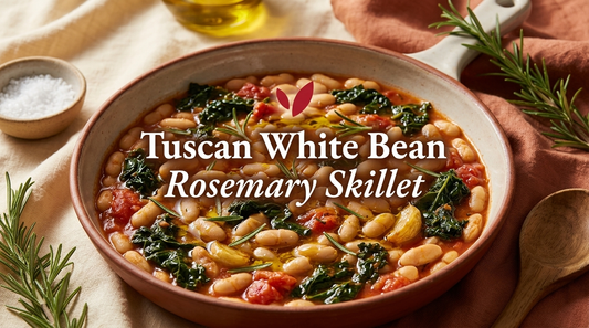 Tuscan White Bean and Rosemary Skillet - creamy cannellini beans with wilted kale, tomato, rosemary and garlic in a glossy olive oil sauce in a rustic ceramic bowl