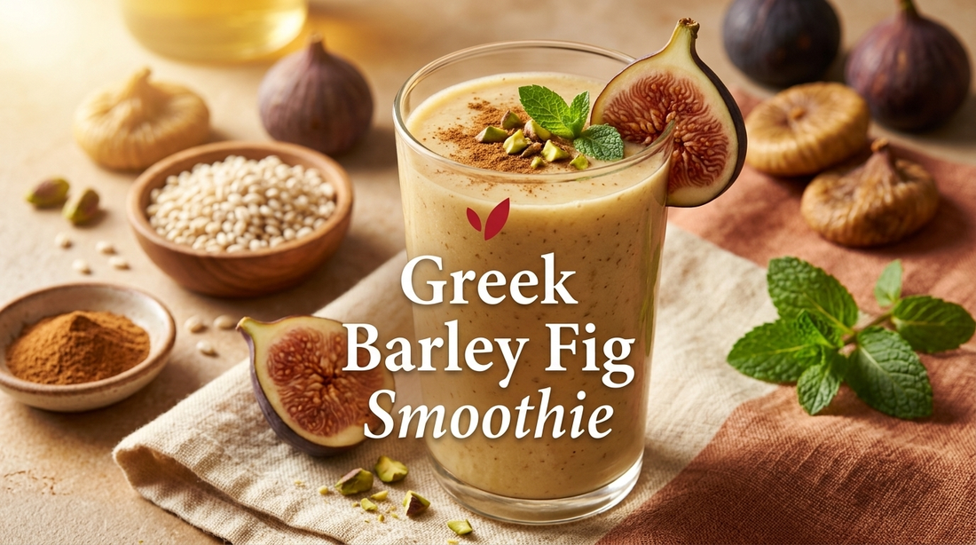 Greek Barley Fig Smoothie - thick creamy beige-gold smoothie in a tall clear glass garnished with a fresh fig slice, mint leaf, cinnamon dusting and chopped pistachios, with dried figs and pearl barley alongside