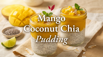 Mango Coconut Chia Pudding in two tall clear glass jars - creamy white coconut chia base layered with vivid golden mango puree, garnished with diced fresh mango, coconut flakes, mint leaf and lime zest